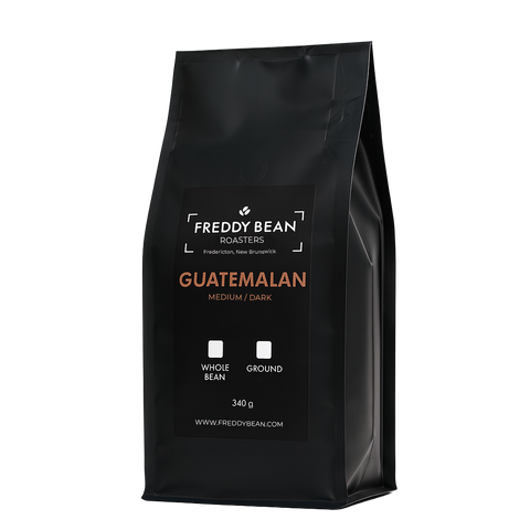 Black coffee bag labeled 'Freddy Bean Roasters Guatemalan' on a white background